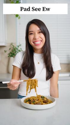 a woman holding a plate of food with the caption pad see ew