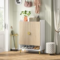 a wooden cabinet with shoes and bags on it in front of a wall mounted coat rack