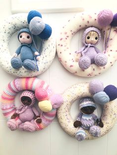 four knitted toys are arranged in the shape of wreaths and rings on a wall