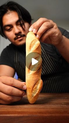 a man holding a long loaf of bread