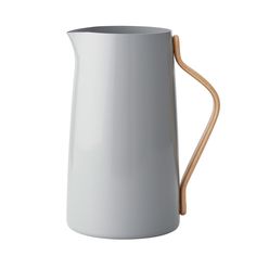 a white pitcher with a wooden handle on a white background, the pitcher is shaped like a vase