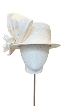 The Orchid Boater is a sensational new piece of sustainable millinery for this season. A statement couture straw hat, made of Panama straw that has been hand woven in Ecuador. It is trimmed with structured silk bow and flower detail. It has a soft elasticated inner ribbon for a comfortable fit. Team with our beautiful Layla Jacket and Zelda Skirt in Cream Tweed to create the most sensational modern occasion wear look. Perfect for Royal Ascot and special summer weddings. Designed in collaboration