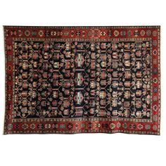 an antique persian rug with many different colors and patterns on the carpet, including red, black