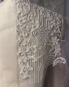 the back of a dress with beading on it