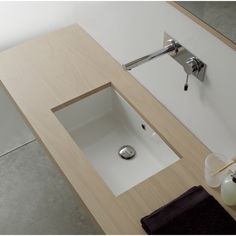 a bathroom sink with a wooden counter top