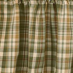 a green and white plaid curtain hanging from a window