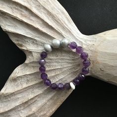 unique piece of jewelry to add to your collection? Look no further than our amethyst and XL silver grey freshwater pearl bracelet & Puka shell closure adds a touch of tropical flair to the perfect for beachy vibes or a night out on the town. Handmade on Maui Spiritual Silver Pearl Bracelet With Gemstone Beads, Elegant Hand-strung Stretch Bracelet For Beach, Silver Amethyst Beaded Bracelets For Meditation, Silver Stretch Bracelet With Natural Stones For Healing, Spiritual Silver Stretch Bracelet With Gemstone, Elegant Silver Stretch Bracelet For Healing, Adjustable Silver Stretch Bracelet With Gemstone, Elegant Gemstone Beads Bracelets For Beach, Elegant Beach Beaded Bracelets With Gemstone Beads