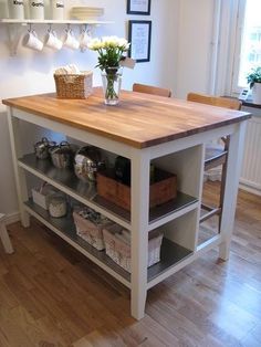 a kitchen island with shelves and baskets on it