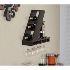 a wooden wine rack with bottles and glasses on it