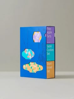 the three books have different designs on them, one is blue and the other is orange