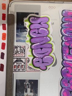 some stickers that are on the side of a laptop computer and it is covered in graffiti