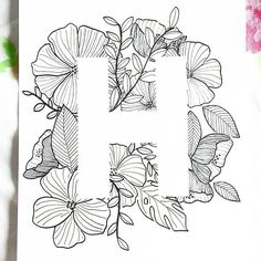 the letter h is surrounded by flowers and leaves