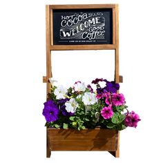 a wooden planter filled with purple and white flowers