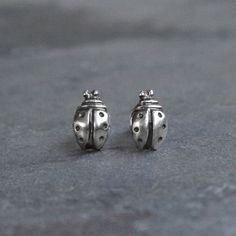 Lucky Lady Bug Stud EarringsLittle talismans to adorn your ears.  Perfect for your next garden party.  Made entirely of solid sterling silver.Sterling silver posts and sterling silver earring backs.Approximately 3/8" x 1/4".For more stud earrings: https://www.etsy.com/shop/KiraFerrer?ref=hdr_shop_menu§ion_id=21332364To see my entire collection: https://www.etsy.com/shop/KiraFerrer Peacock Pearls, Nature Earrings, Lucky Ladies, Love Bug, Pearl Bangle, Love Bugs, Gorgeous Bracelet, Lady Bug, Circle Earrings