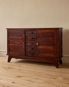 an old wooden cabinet with drawers on one side and two doors on the other end