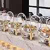 a long table is set up with silver and gold dishes