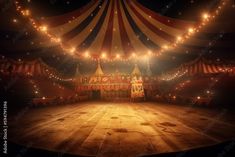 an empty circus tent with lights on the ceiling