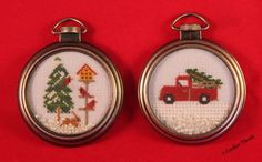 two cross stitch key chains with christmas pictures on them