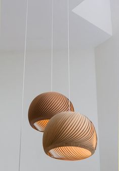 three wooden lights hanging from the ceiling in a room