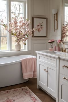 a bath room with a tub a sink and some flowers in vases on the windowsill