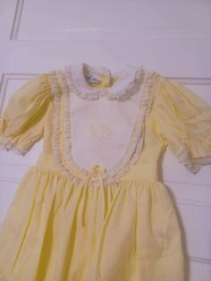 "Vintage Cari Classic Girls yellow Dress Gingham Lace white Trim no size 4?  No size lablel but measures as follows Shoulders, 11\"Waist  12\"Chest 13\" length from shoulder to hem line 23 in good condition but the  elastic in the sleeve are loose (p10-12)(b" White Peter Pan Collar Dress For Spring, White Spring Dress With Peter Pan Collar, Yellow Short Sleeve Dress For Dress-up, Yellow Fitted Dress For Dress-up, Fitted Yellow Dress For Dress-up, Cute White Dress With Peter Pan Collar, Yellow Dress For Spring Dress-up Occasions, Yellow Dress For Spring Dress-up Events, Spring Yellow A-line Vintage Dress