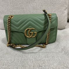 Gg Marmont Flap Bag Matelasse Leather Green Gucci Travel Bag, Gucci Green Crossbody Bag, Green Gucci Crossbody Bag, High-end Green Shoulder Bag With Gold-tone Hardware, Green Gucci Bag With Gold-tone Hardware, Green Gucci Crossbody Shoulder Bag, Gucci Green Bags With Gold-tone Hardware, Green Gucci Bag For Everyday Use, Designer Green Bags With Branded Hardware