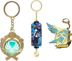 three keychains with different designs on them, one is blue and the other has gold