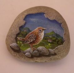 a painted rock with a bird on it