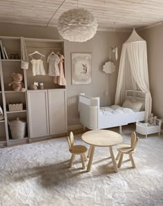 a baby's room with a crib, bed, and table in it