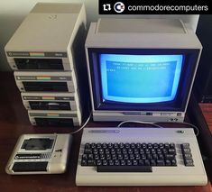 an old computer sitting on top of a wooden desk next to a small keyboard and mouse