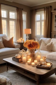 a living room filled with lots of furniture and candles on top of a coffee table