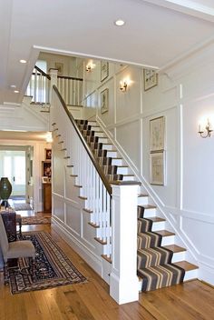 a living room filled with furniture and a stair case