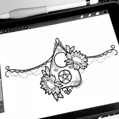 a tablet with a drawing on it sitting next to a pen and inking pad