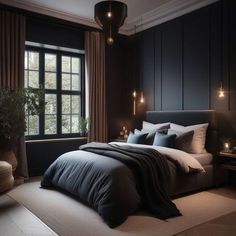 a bedroom with black walls and white bedding is lit up by candle lights on either side of the bed