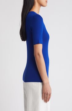 This lightweight, fine-gauge sweater provides a pop of color to perk up your everyday look. Jewel neck Short sleeves 72% rayon, 28% polyester Dry clean Imported Solid Fine Knit Tops For Workwear, Modern Solid Color Fine Knit Tops, Blue Stretch Knit Top For Layering, Versatile Blue Crew Neck Top, Classic Blue Knit Tops, Blue Fitted Short Sleeve Sweater, Blue Fitted Top With Ribbed Neckline, Blue Fine Knit Sweater For Work, Blue Workwear Top With Ribbed Neckline