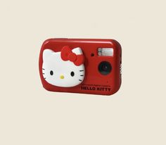 a red hello kitty camera with a white bow on it's head is shown