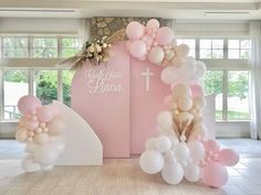 balloons and flowers decorate the entrance to a church