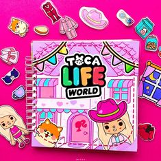 a notebook with stickers on top of it next to some toys and magnets