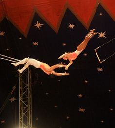 two men performing acrobatic tricks in the air