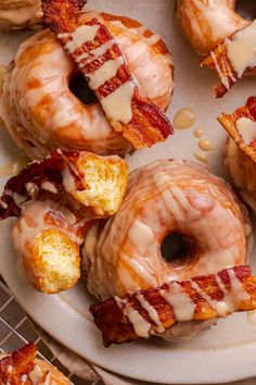 glazed donuts with bacon and white glazes on a plate next to other doughnuts