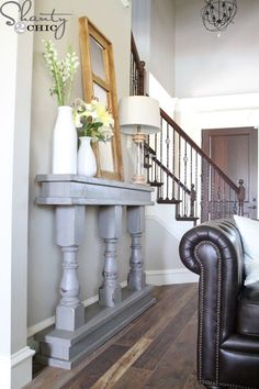 a living room filled with furniture and a stair case