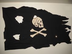 a pirate flag with a skull and crossbones on the front is torn in half