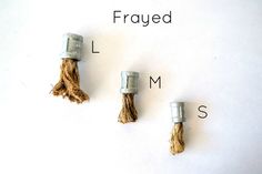 three tassels with the words frayed and l m s written below them