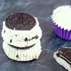 three oreo cookies sitting next to each other on top of a table with white frosting