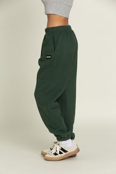 Elevate your athleisure style and feel like you're lounging on the go with our Hunter Green GH Jogger Sweatpants. The elastic waistband and tapered leg style allows you to feel secure and trendy. Complete with dual side pockets to keep your essentials close by. Pair with ur Hunter Green GH Cropped Hoodie to complete the set. Affordable Green Athleisure Sweatshirt, Green Sweats Outfit, Green Sweatpants, Athleisure Style, Green Joggers, Tennis Skirts, Athleisure Fashion, Athletic Top, Green Pants