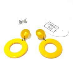 Sunshine or bright yellow Go-Go hoop drops from vintage aura glow lucite studs. Geometric lucite earrings made with vintage parts. These are big & make a statement. Mod meets 80's opulence. Measures just under 2.25" or 60mm from top to bottom, but super lightweight with just enough swing to make a statement. Earrings are made with vintage lucite parts that were made in Rhode Island in the 1960's - early 80's by Best Plastics. We hand-set them with surgical steel earring posts and they have sturd Yellow Retro Party Earrings, Retro Yellow Earrings For Party, Retro Yellow Party Earrings, Bold Yellow Drop Earrings, Yellow Round Hoop Earrings For Party, Lucite Earrings, Surgical Steel Earrings, Earring Posts, Vintage Lucite