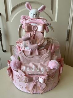 a pink baby shower cake on top of a table