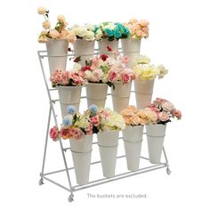 a bunch of white vases with flowers on top of each one in front of a white background