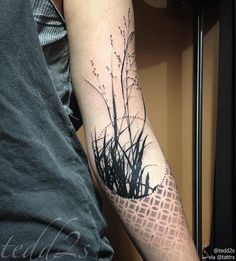 a person with a black and white tattoo on their arm