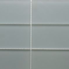 a white tiled wall with lines on it